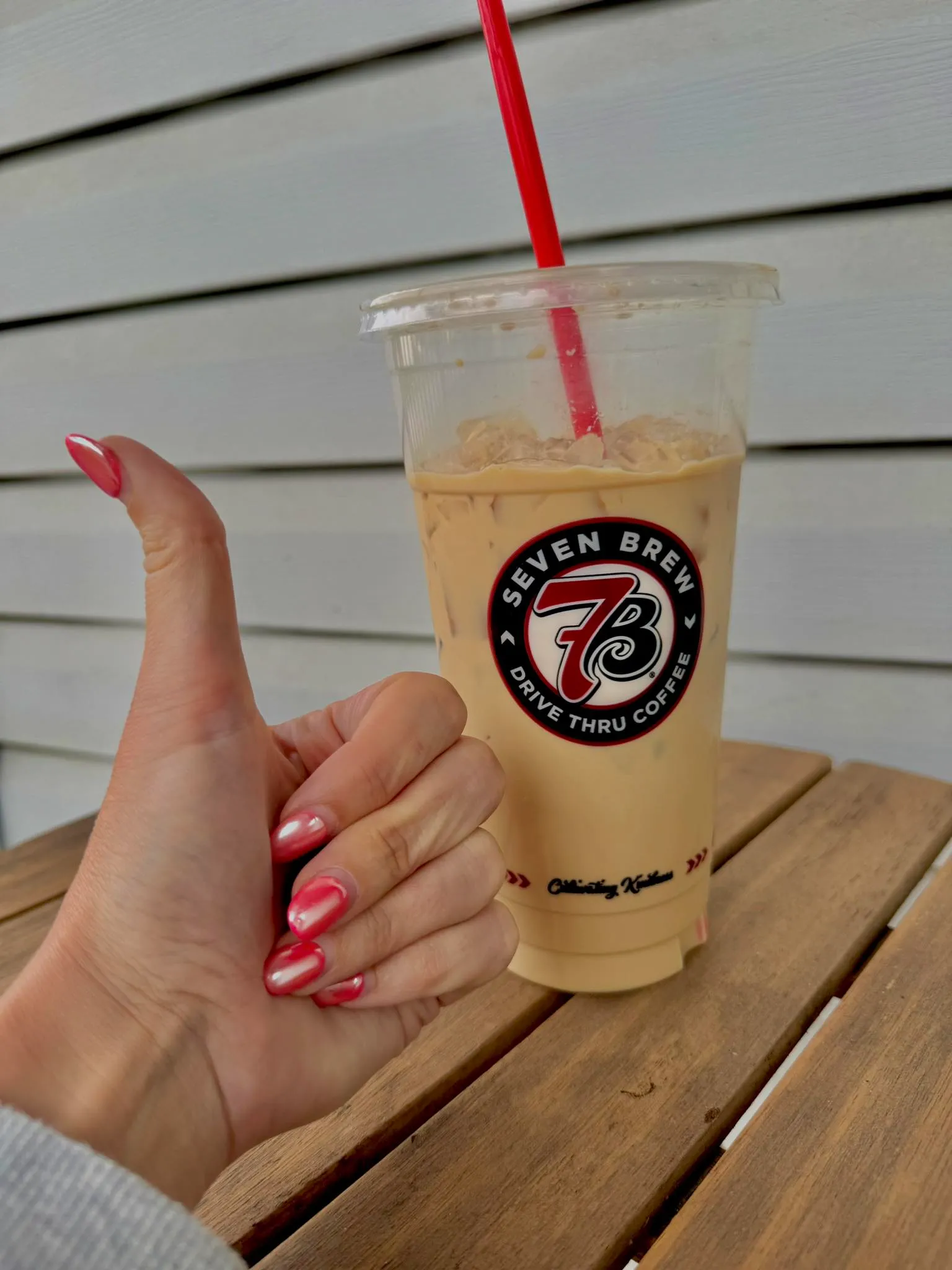 7 Brew barista adding syrup to a custom drink at the drive-thru window