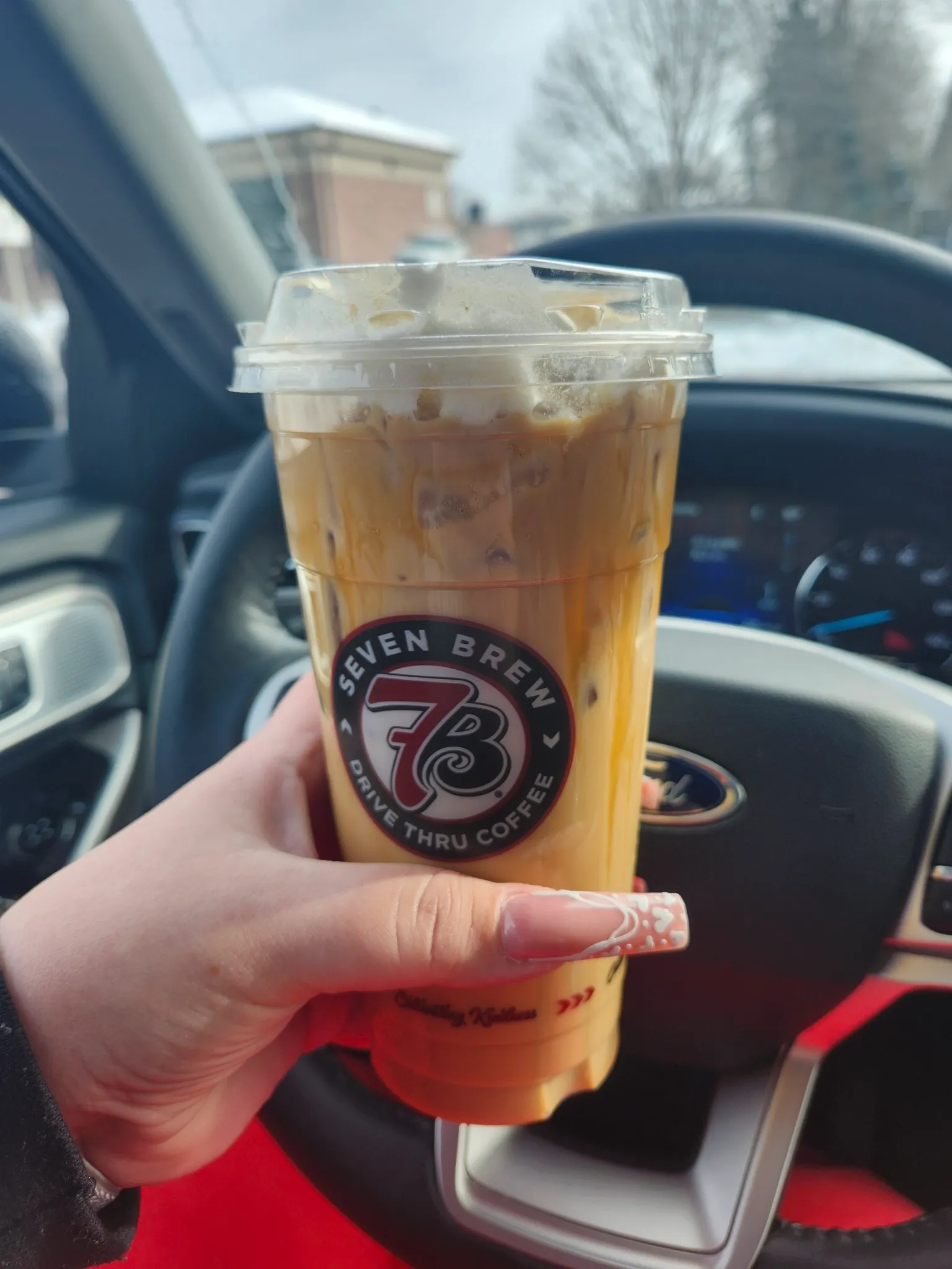 Iced flavored latte from 7 Brew drive-thru with caramel drizzle